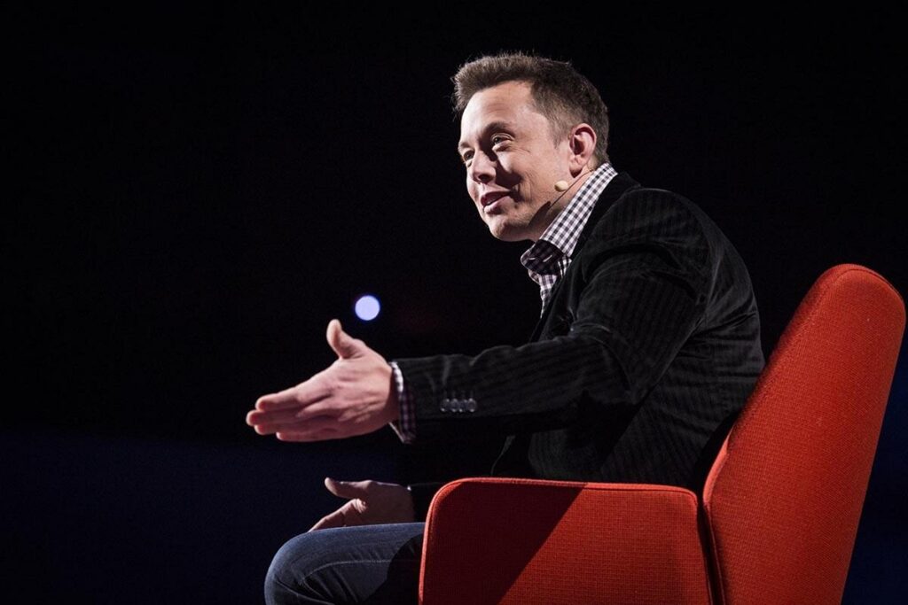 Elon Musk on red chair